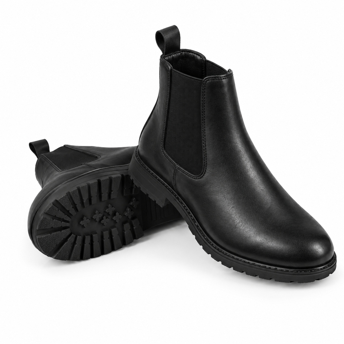 A pair of black leather Chelsea boots, with one boot standing upright to show the side profile and elastic side gore, and the other lying on its side to display the textured black rubber sole.