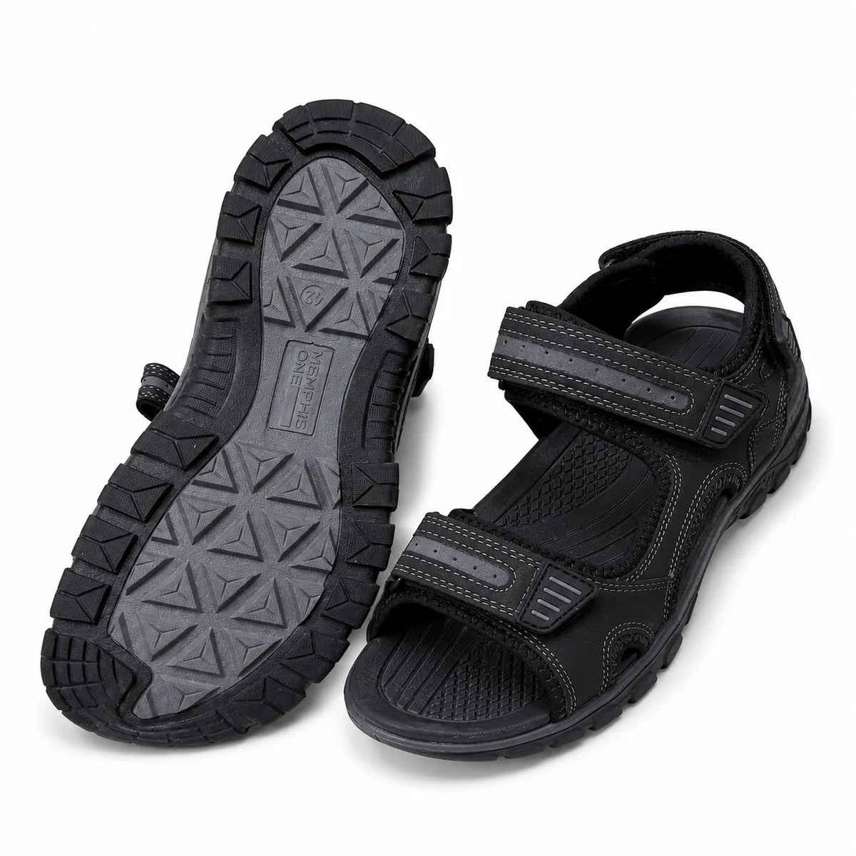 A pair of black athletic sandals, with one sandal showing the textured outsole and the other showing the top strap closure, on a white background.